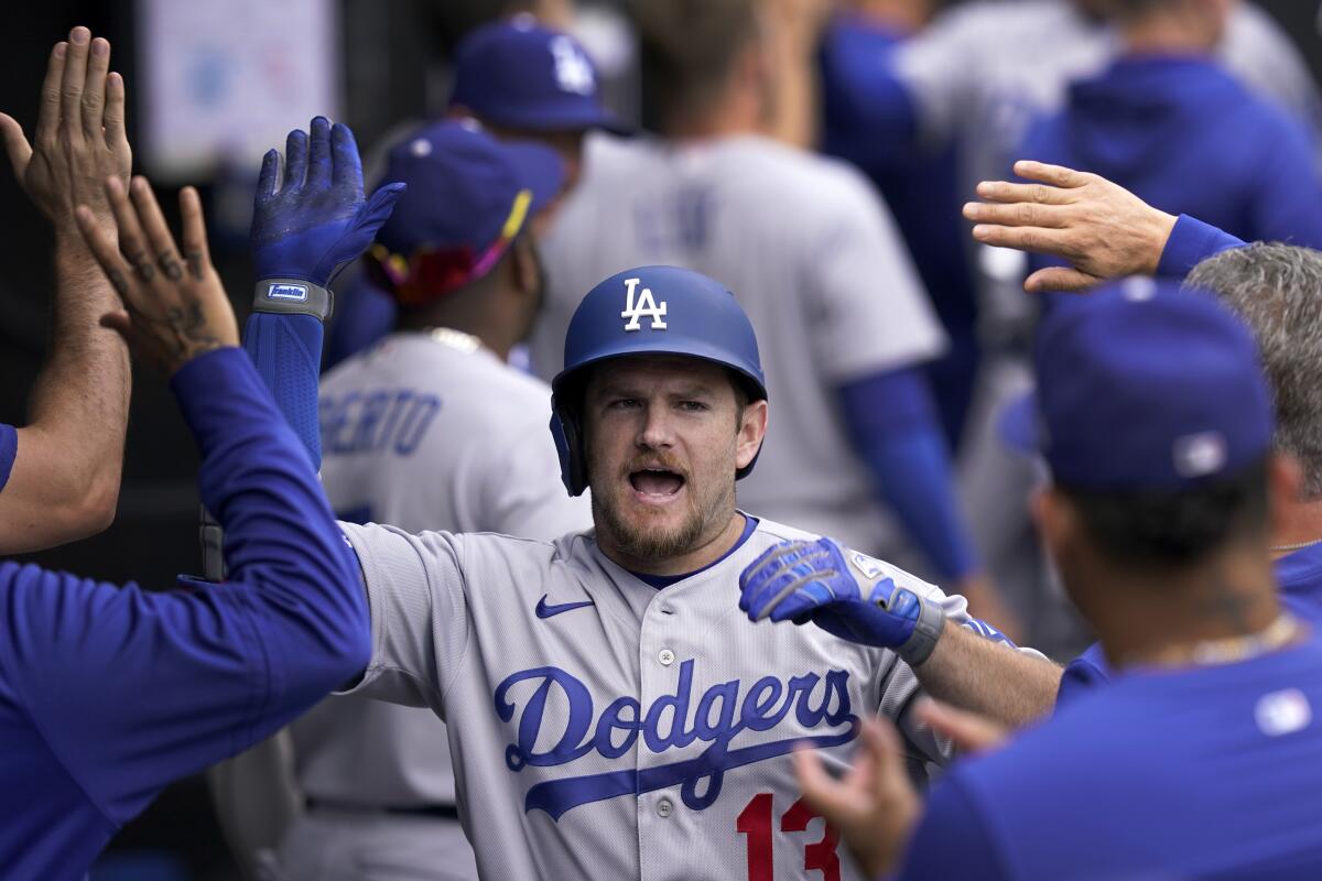 Los Angeles Dodgers' Max Muncy celebrates his three-run home run off Chicago White Sox relief pitcher Bennett Sousa during the sixth inning of a baseball game Thursday, June 9, 2022, in Chicago. (AP Photo/Charles Rex Arbogast)