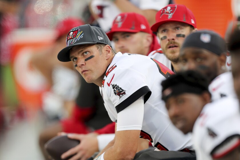 Tampa Bay Buccaneers quarterback Tom Brady sits on the bench.