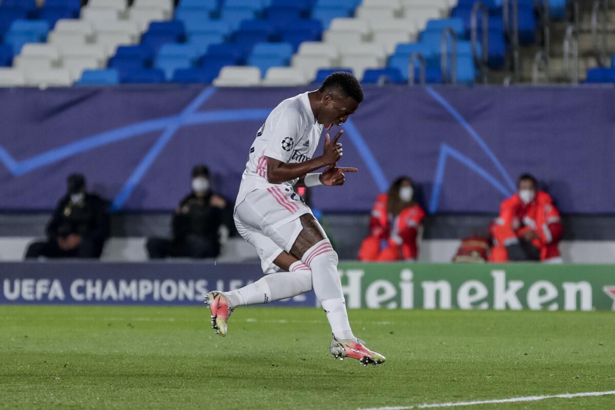 Real Madrid's Vinicius Junior celebrates after scoring his second goal during the Champions League quarterfinal first leg, soccer match between Real Madrid and Liverpool at the Alfredo di Stefano stadium in Madrid, Spain, Tuesday, April 6, 2021. (AP Photo/Manu Fernandez)