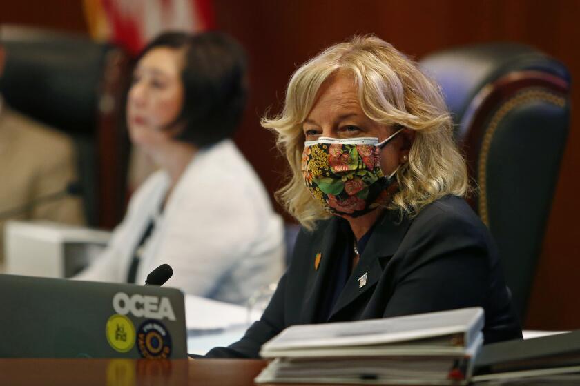 County Supervisor Katrina Foley listens during public comments for an Orange County Board of Supervisors meeting in Santa Ana on Tuesday, August 10, 2021.