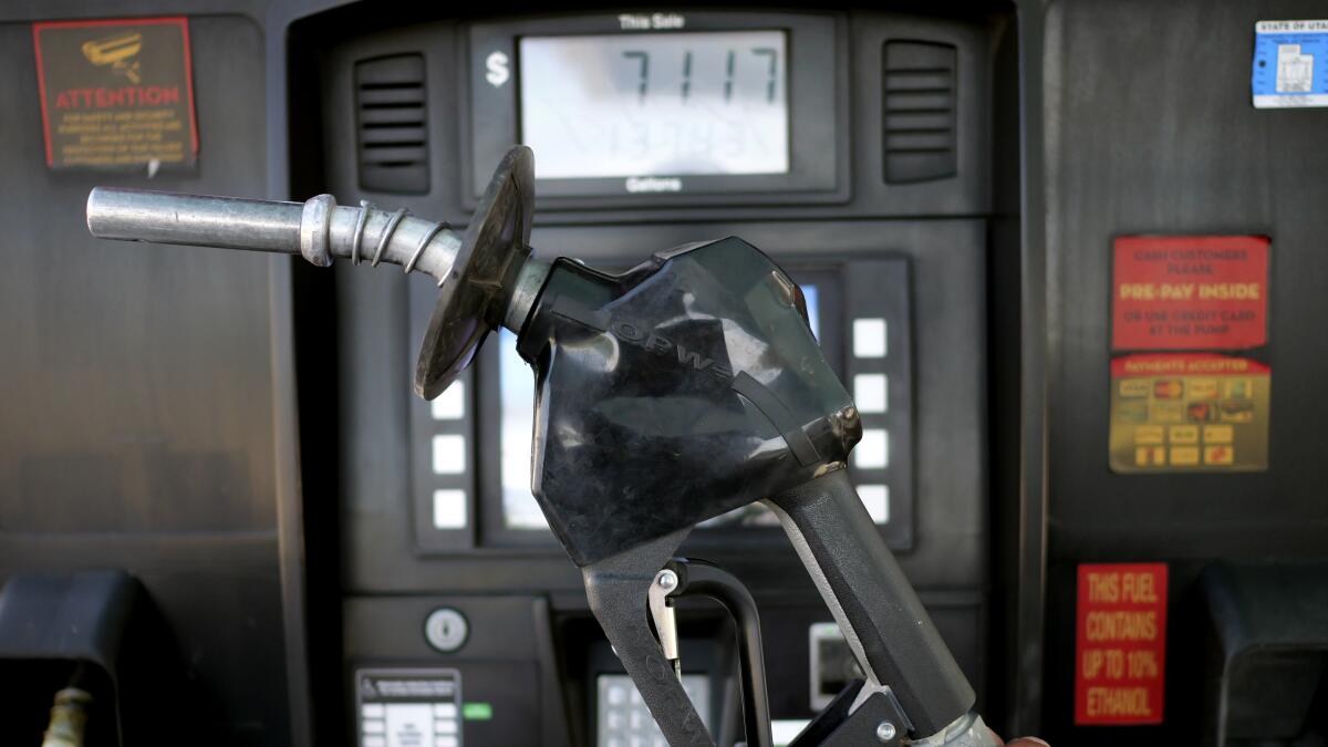 FILE - A gasoline pump is shown at a gas station Friday, June 10, 2022, in Salt Lake City. With record-high gas prices, travelers can save money on summer road trips by considering alternatives. They can plan a trip to U.S. regions with lower-cost fuel, like the Midwest or South. If travelers need to rent a car, they might find affordable options by going to a cheaper car rental location or considering a car rental alternative like car sharing. With more hotels offering electric vehicle charging, renting an electric car could be more convenient and less expensive than expected. No matter what car or region, spending on a rewards credit card, particularly one that earns extra points on gas, could help lessen the sting of road trip expenses.(AP Photo/Rick Bowmer, File)