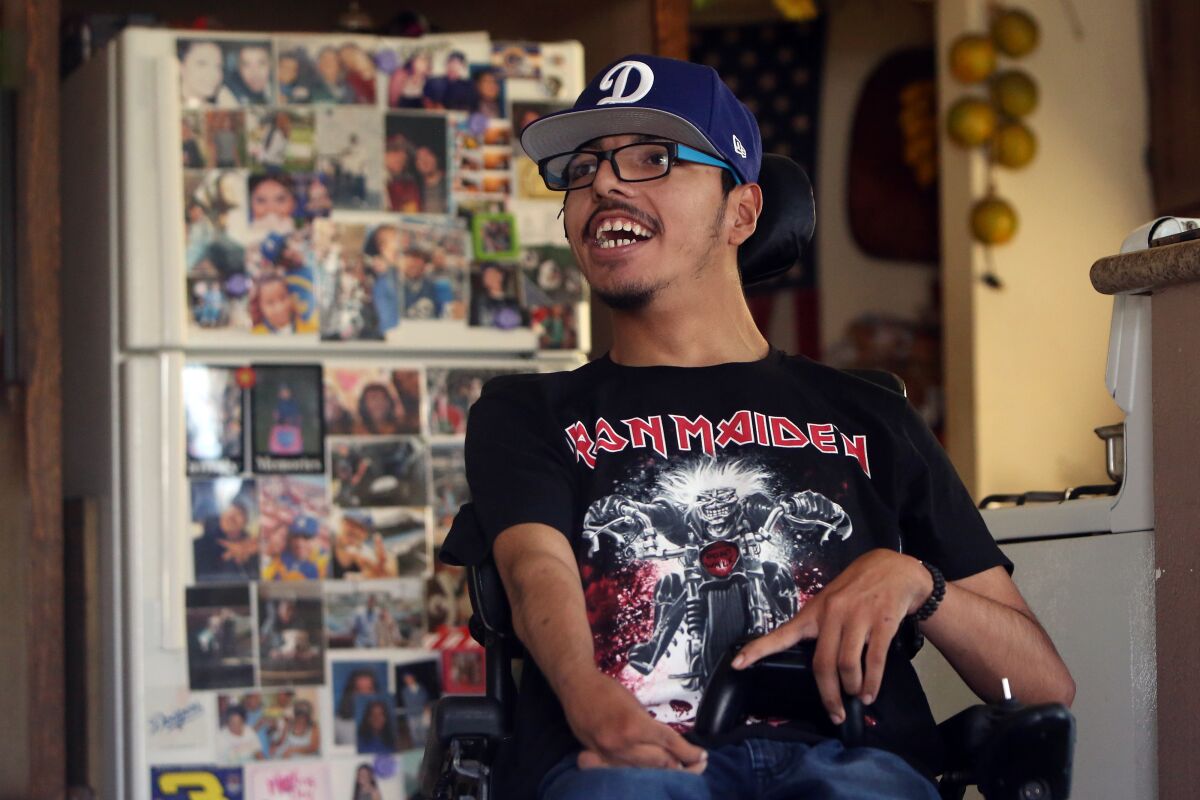 Darlin Peña, 19, who has cerebral palsy and attends Banneker Career and Transition Center, plays a video game at home.