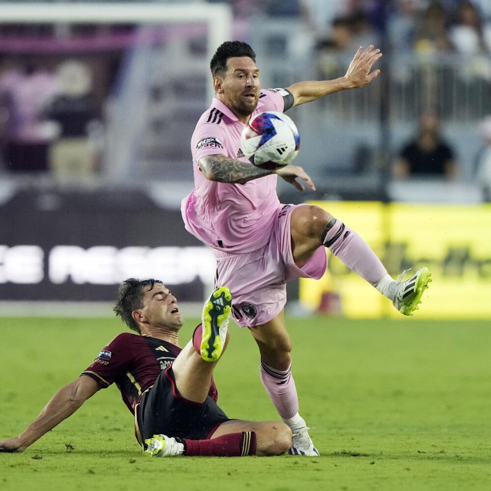 Atlanta United midfielder Santiago Sosa, left, defends against Inter Miami forward Lionel Messi.