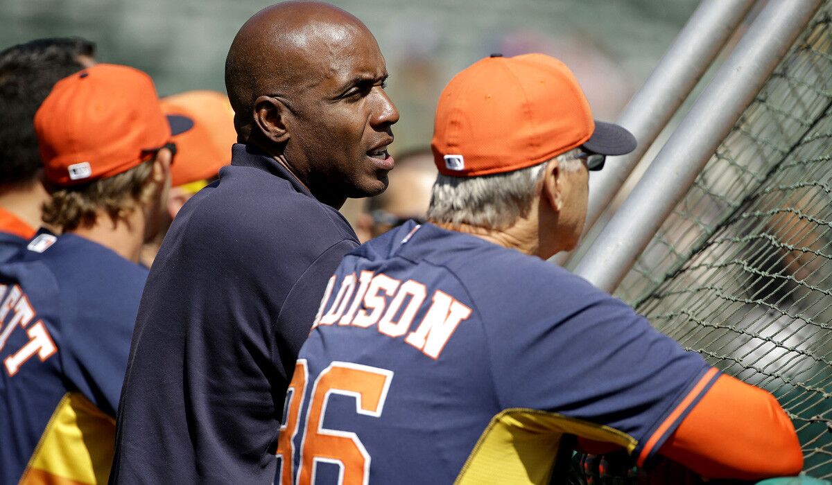 Former Giants slugger Barry Bonds, center, talks with Houston Astros special assignment coach Dan Radison during batting practice before a game against the Oakland A's this month.