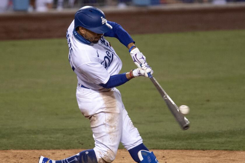 Los Angeles Dodgers' Mookie Betts hits a two-run home run during the eighth inning.