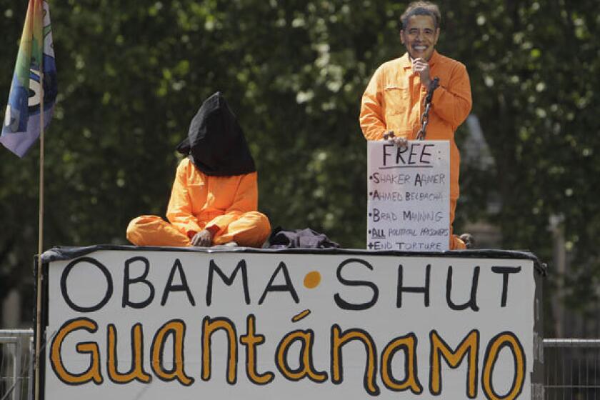 In this May 25, 2011 photo, protesters demonstrate outside Britain's Houses of Parliament in central London, where President Obama was to give an address. On Wednesday, a federal judge ruled that provisions of a defense authorization act signed by Obama are unconstitutional because they could subject activists to military detention.