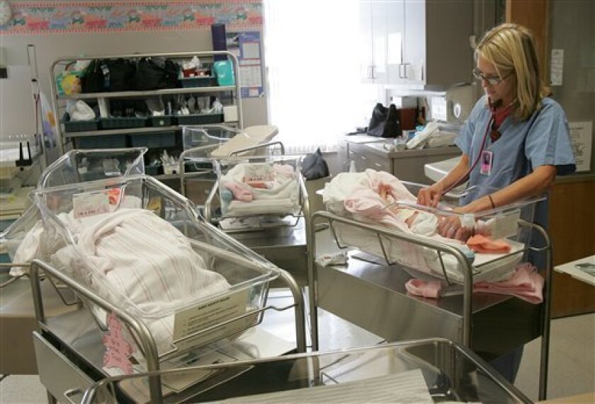 (2009 file photo) Nurse Jozie Kovar checks the heartbeat of a baby at Jamestown, N.D. Hospital. / photo by John M. Steiner * The Jamestown Sun (AP)