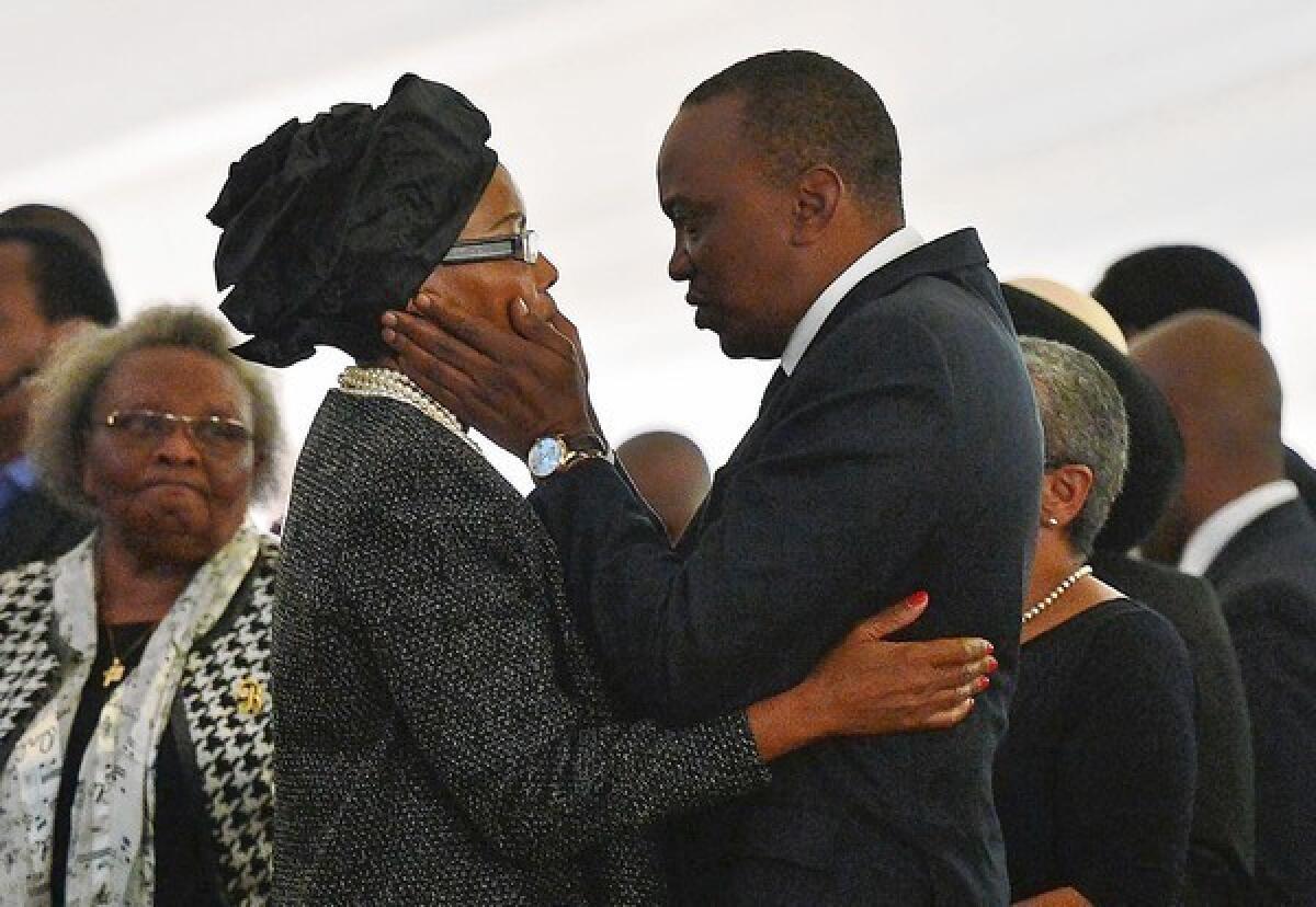 Kenyan President Uhuru Kenyatta comforts his sister Catherine Mwangi at the funeral of her son and her son's fiancee. Both were killed in the terrorist attack on the Westgate shopping mall in Nairobi. News reports have raised questions of whether some security units went into the mall on a mission to save a group of VIPs.
