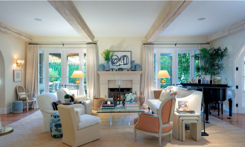 The Italianate home JoBeth Williams and John Pasquin bought feaures a beamed-ceiling living room with a fireplace.