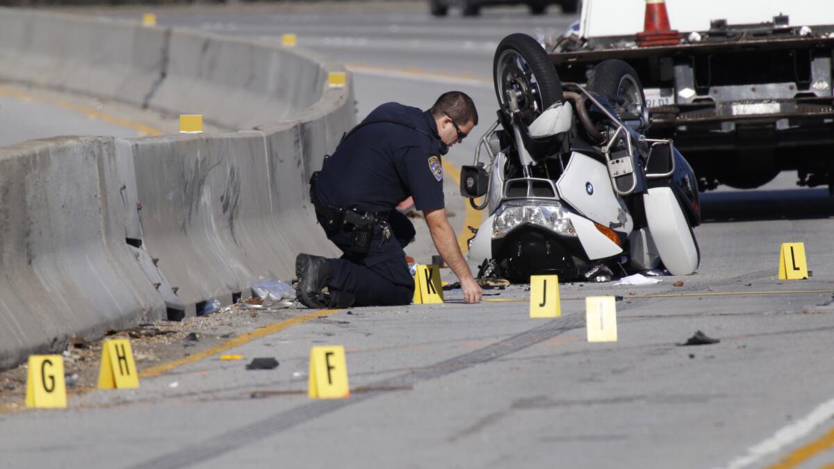 A CHP Accident Investigation Team member takes measurments at the scene after a CHP motorcycle officer was injured a in a crash on the northbound lanes of the 170 Freeway at Burbank Blvd.