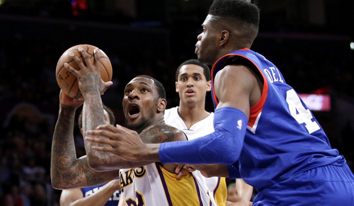 Lakers forward Tarik Black drives to the basket against 76ers forward Nerlens Noel in the first half last Sunday evening at Staples Center.