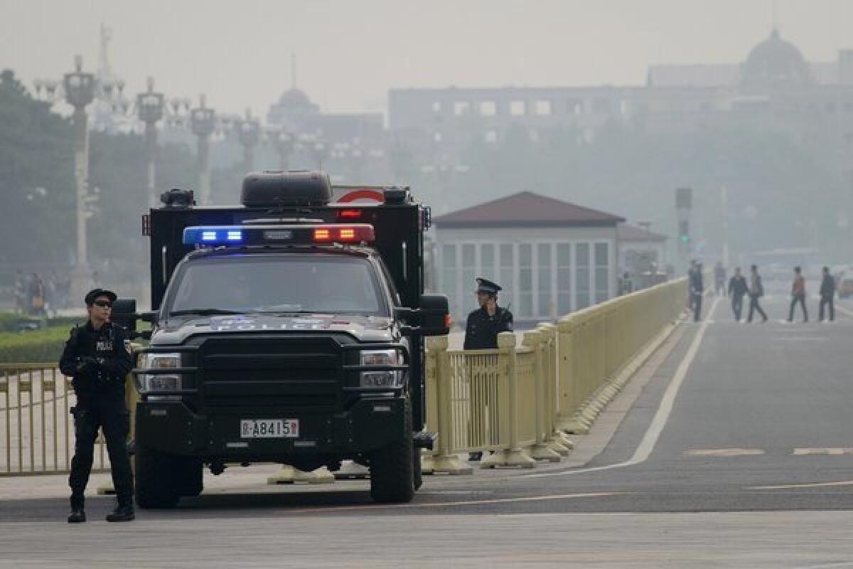 Armed police stand guard at Tiananmen Square in Beijing on Thursday.