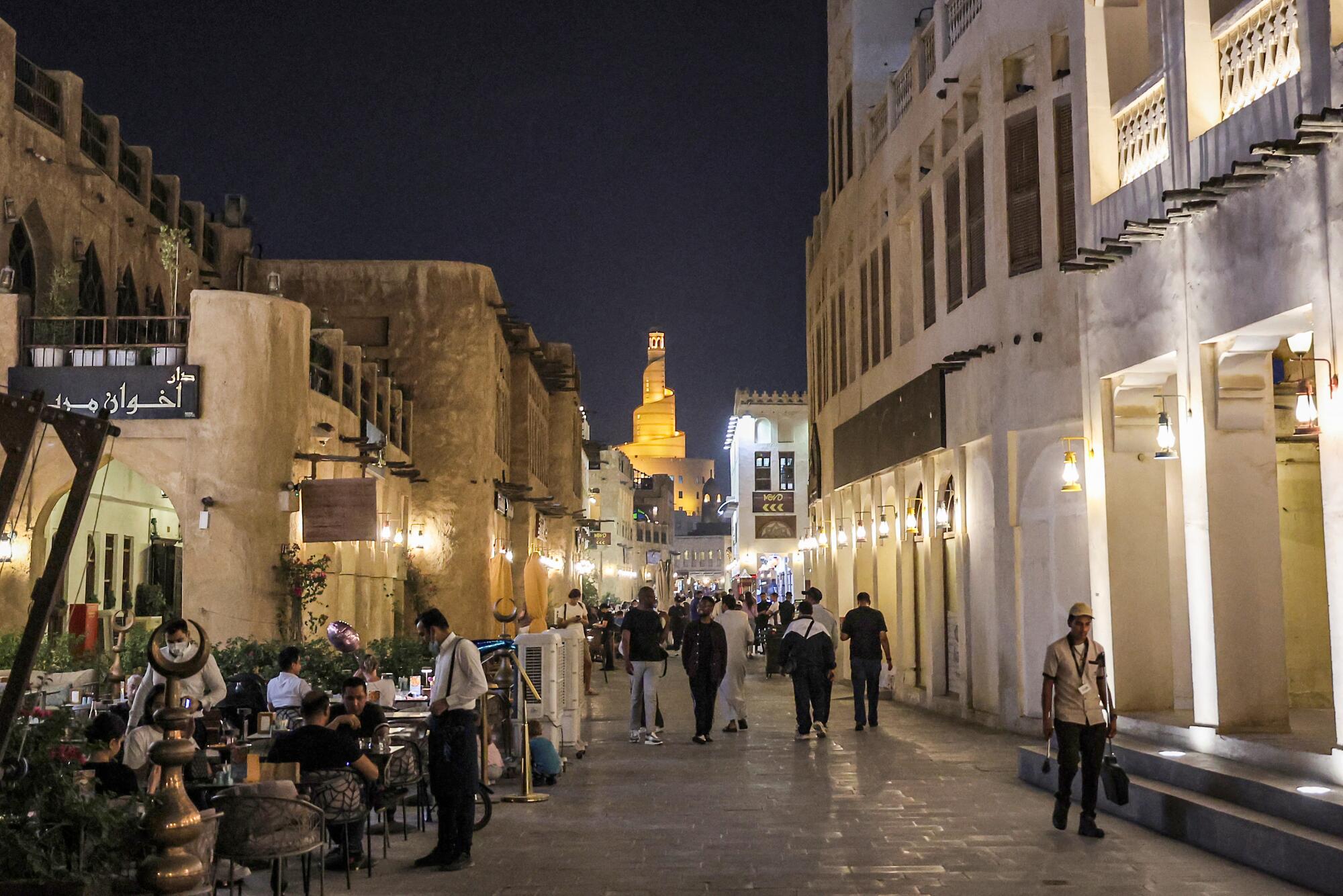 People walk along an alley in in Doha's Souq Waqif.