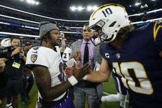 Chargers quarterback Justin Herbert congratulates Ravens quarterback Lamar Jackson (8).