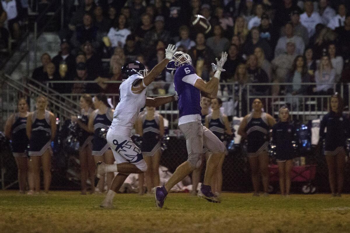 St. Anthony's Riley Jenkins catches a long pass and scores a touchdown against Newport Harbor in the first round of the CIF Southern Section Division 9 playoffs on Friday at Clark Field in Long Beach.