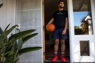 Long Beach, CA - March 03: Portrait of Kade Weston in the doorframe of his home before he practice.