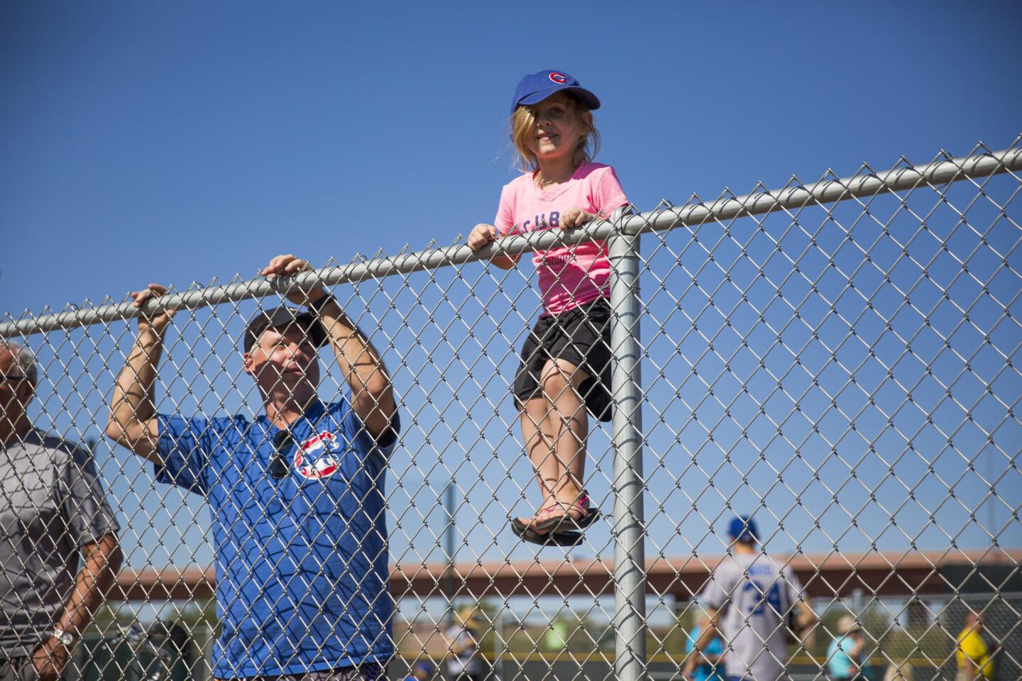 From left, David Slade, 41, and his daughter Madison Slade, 5, watch the Cubs practice, Feb. 26, 2016.