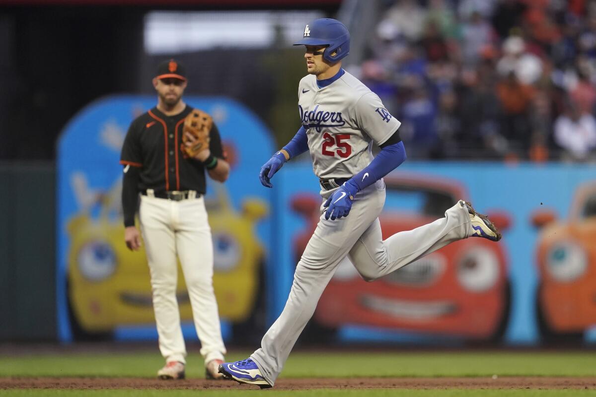 The Dodgers' Trayce Thompson runs past Giants third baseman Evan Longoria as he rounds the bases Sept. 17, 2022. 