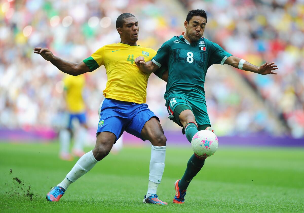 LONDON, ENGLAND - AUGUST 11: Juan Jesus of Brazil competes with Marco Fabian of Mexico during the Men's Football Final between Brazil and Mexico on Day 15 of the London 2012 Olympic Games at Wembley Stadium on August 11, 2012 in London, England. (Photo by Michael Regan/Getty Images)
