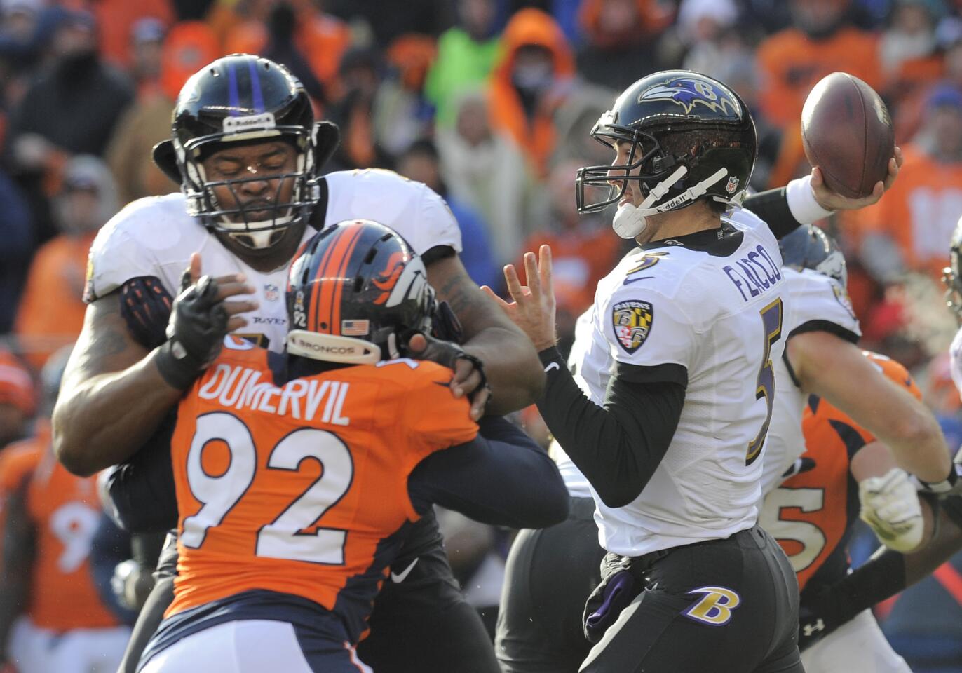 Ravens OT Bryant McKinnie blocks Elvis Dumervil as he pursues Joe Flacco. The Ravens agreed to terms on a five-year, $35 million deal with the former Denver Broncos defensive end.