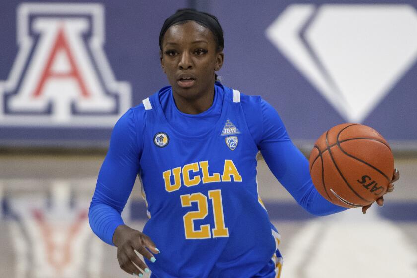 UCLA Bruins forward Michaela Onyenwere (21) handles the ball against the Arizona Wildcats.