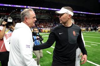 USC coach Lincoln Riley, right, greets TCU coach Sonny Dykes after the Trojans' overtime loss in the Alamo Bowl.