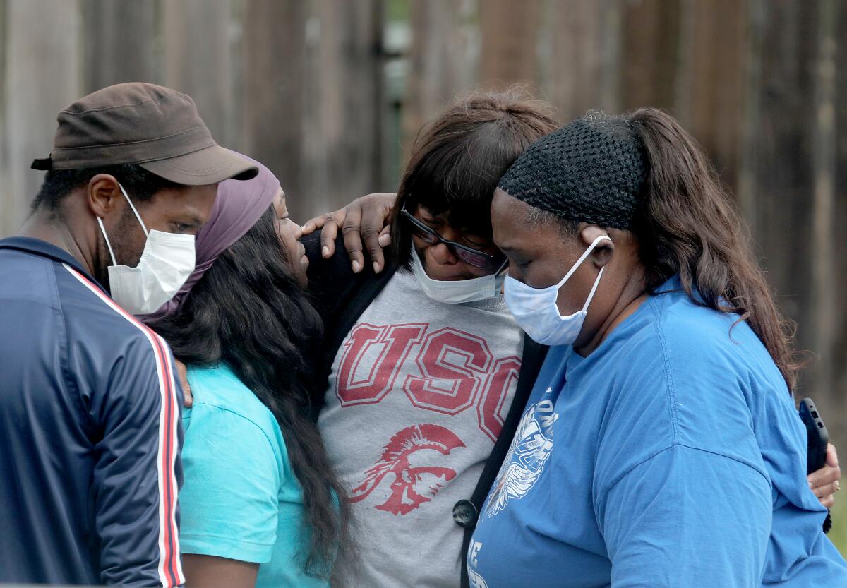 Relatives and friends of Dijon Kizzee gather at the site where Kizzee was shot.