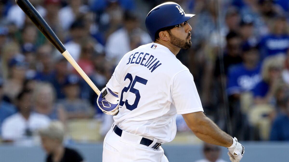 Dodgers left fielder Rob Segedin watches his two-run double as he breaks from the batter's box during the fourth inning Sunday.