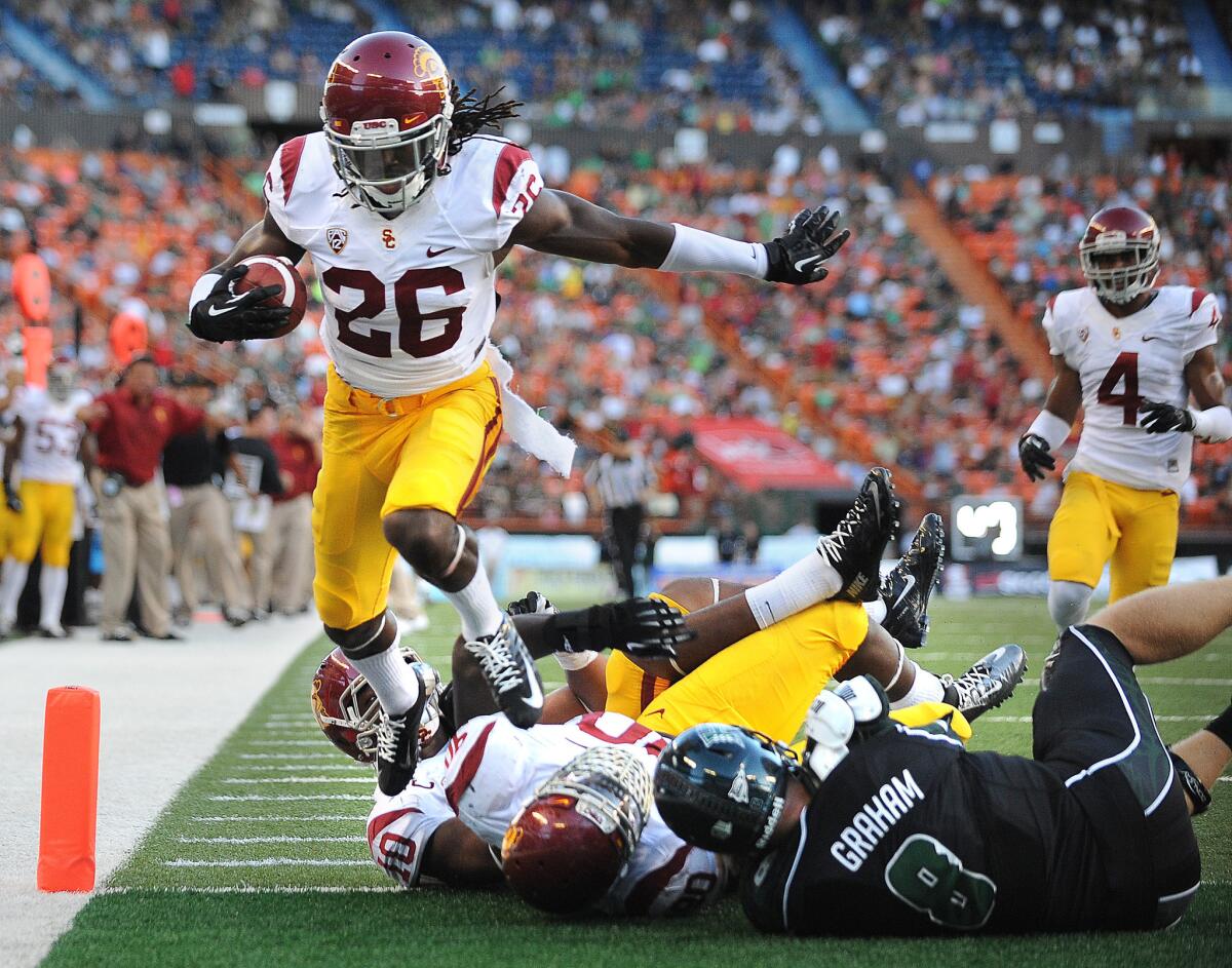 USC's Josh Shaw, left, returns an interception for a touchdown in front of Hawaii quarterback Taylor Graham in August 2013.