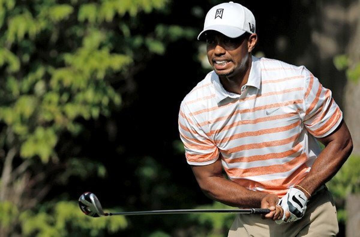 Tiger Woods watches his tee shot at No. 13 during the second round of the Memorial on Friday.