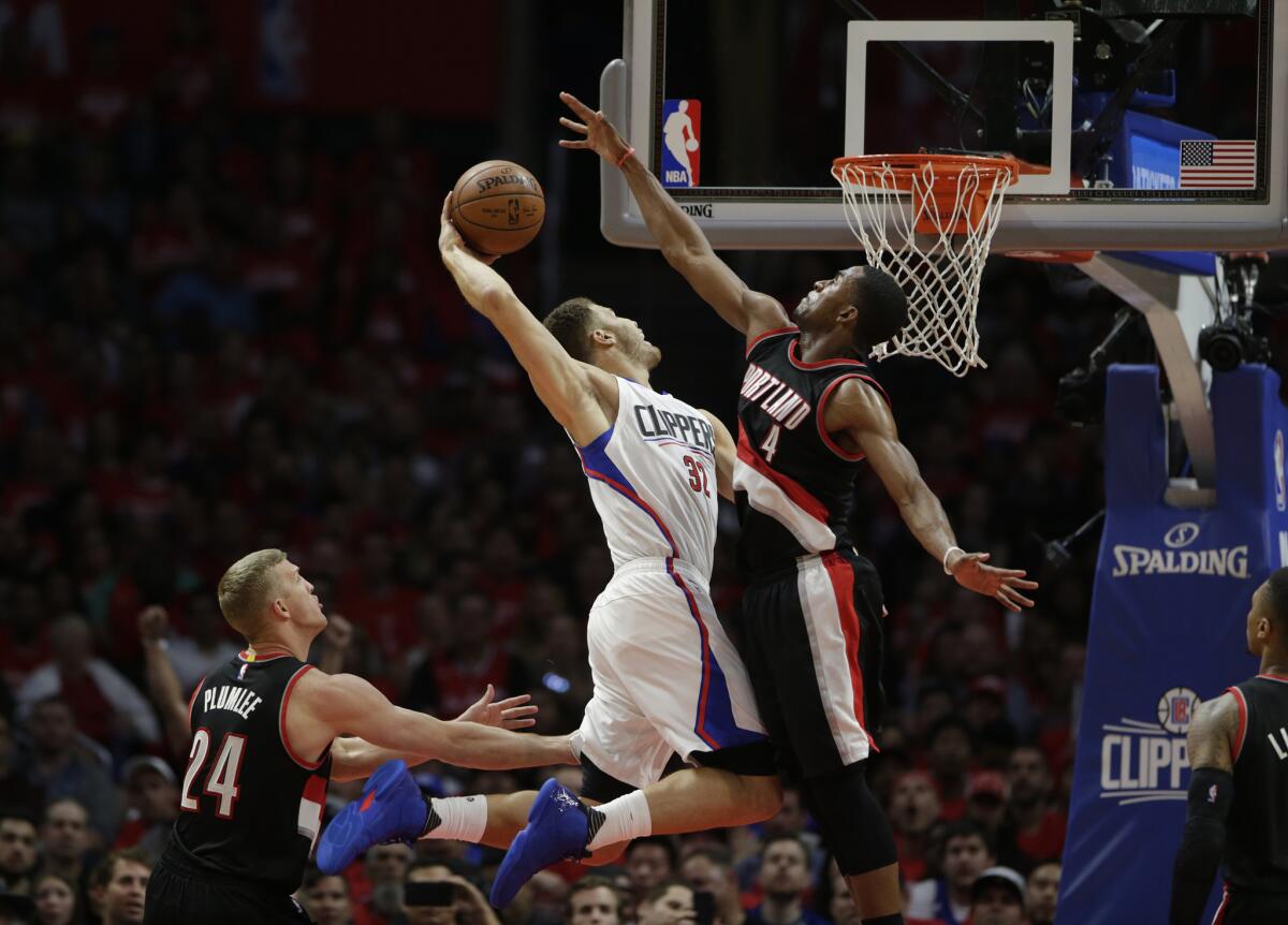 Clippers power forward Blake Griffin attacks the basket between Trail Blazers defenders Mason Plumlee (24) and Maurice Harkless (4) during the fourth quarter of Game 2.