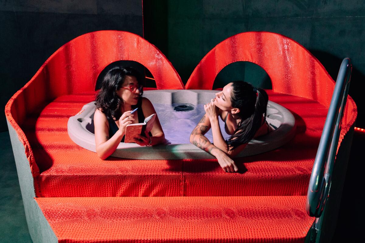 Two women chat in a hot tub.