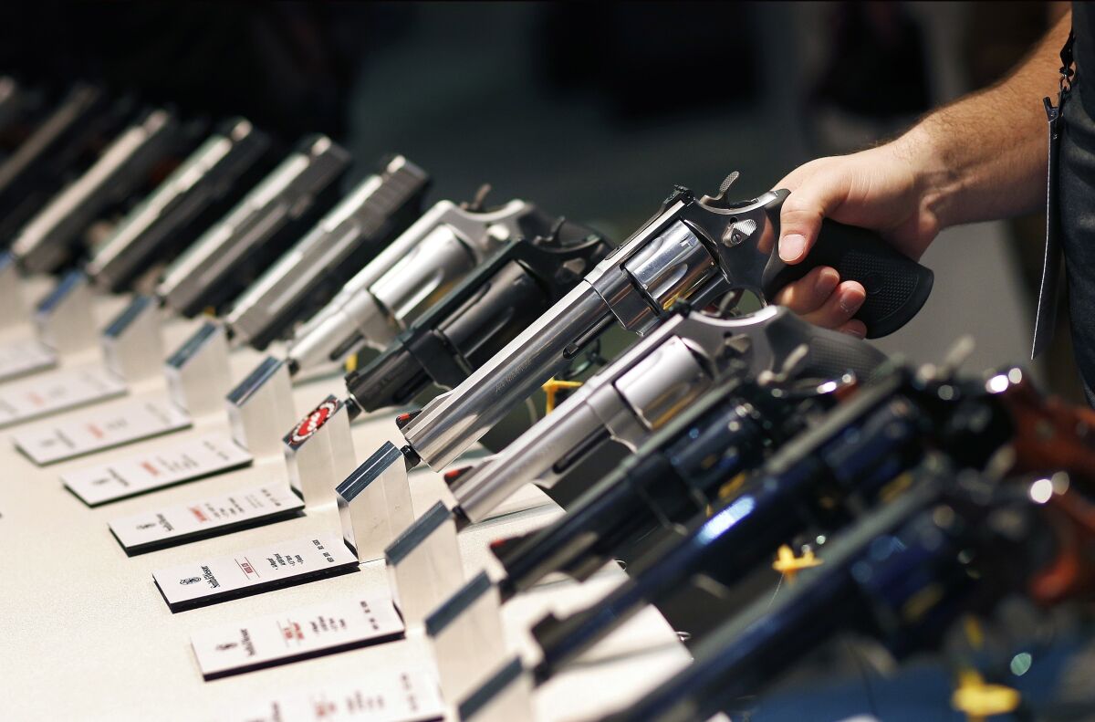 In this Jan. 19, 2016, file photo, handguns are displayed at the Smith & Wesson booth at a trade show.