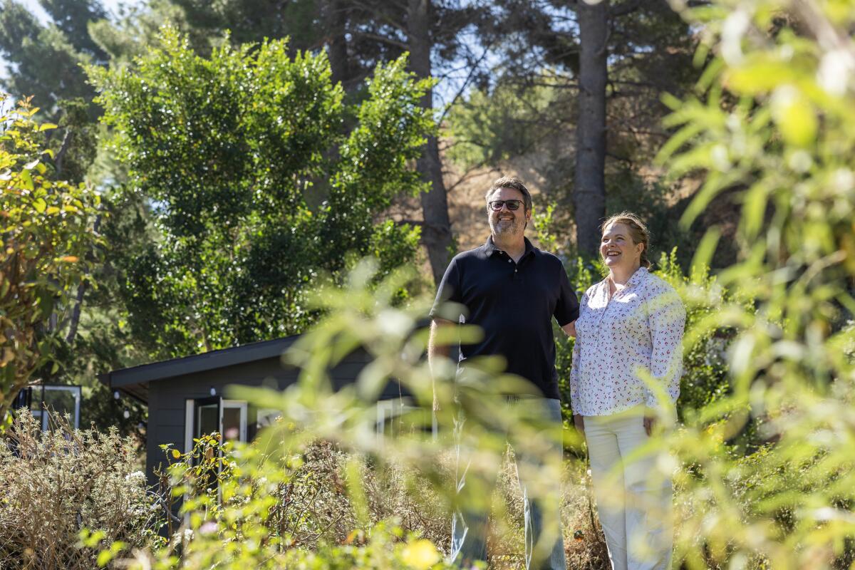 Phil and Margaret Hinch stand among the greenery of their native plant garden in Porter Ranch.