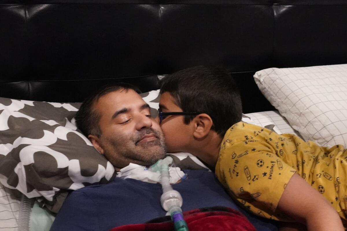 Keaton Kotiya, 9, kisses his father Rupesh as he readies for bed.