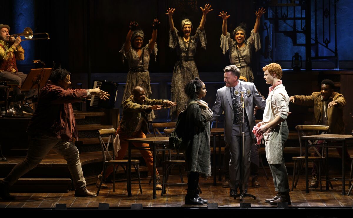 Actors perform onstage.