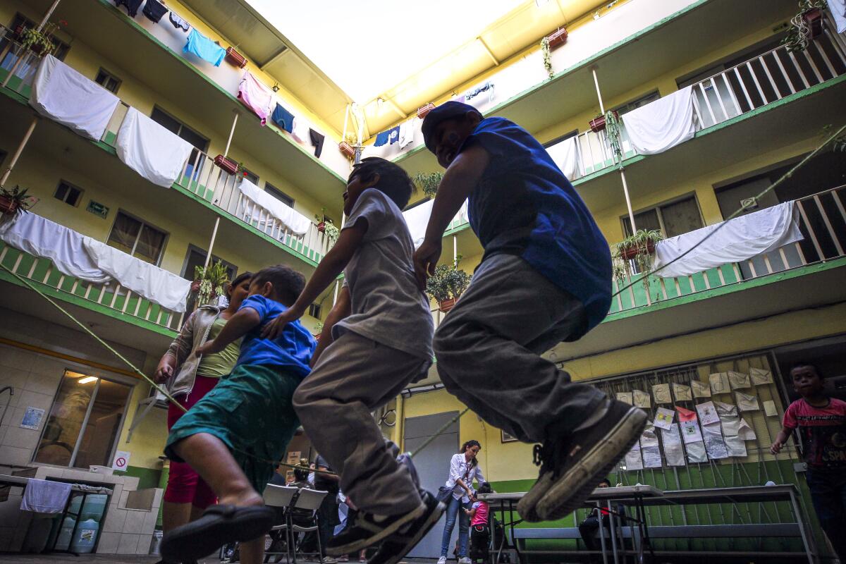 Children play with a jump rope while in the courtyard of Casa del Migrante, a shelter for migrants, asylum seekers, and deportees, on Friday, August 16, 2019 in Tijuana, Mexico.