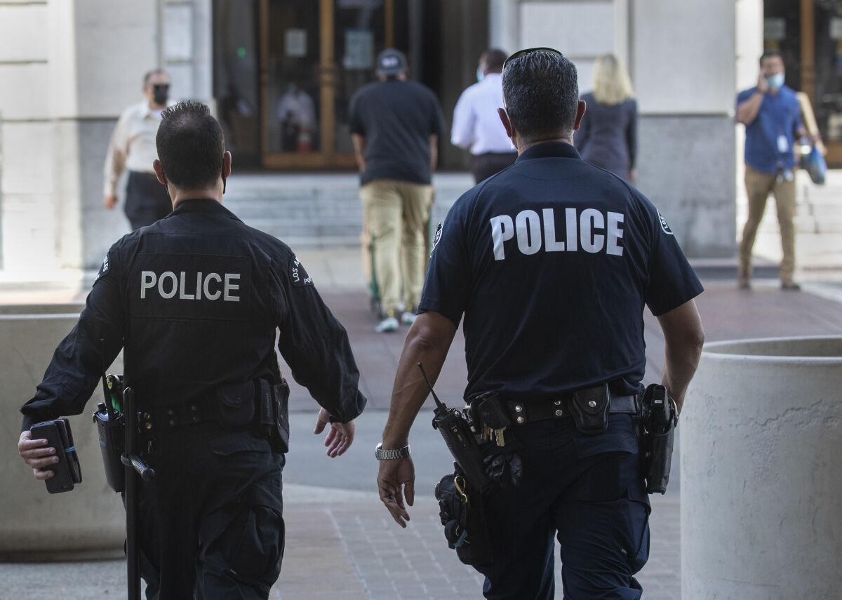 LAPD officers walk toward Los Angeles City Hall.