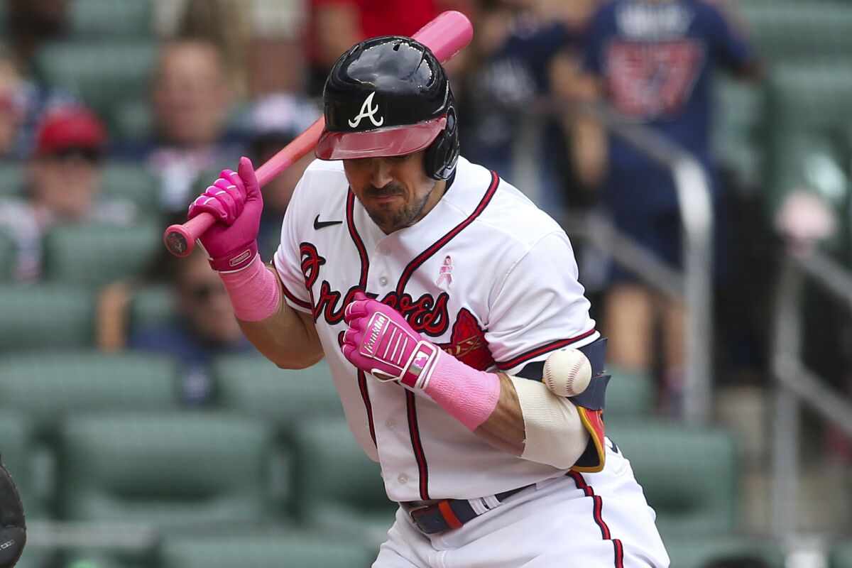 Atlanta Braves center fielder Adam Duvall (14) is hit by a pitch in the fifth inning of a baseball game against the Milwaukee Brewers, Sunday, May 8, 2022, in Atlanta. (AP Photo/Brett Davis)