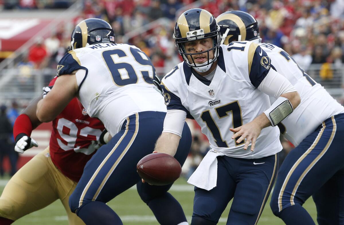 Rams quarterback Case Keenum looks to hand off the ball against San Francisco on Jan. 3.