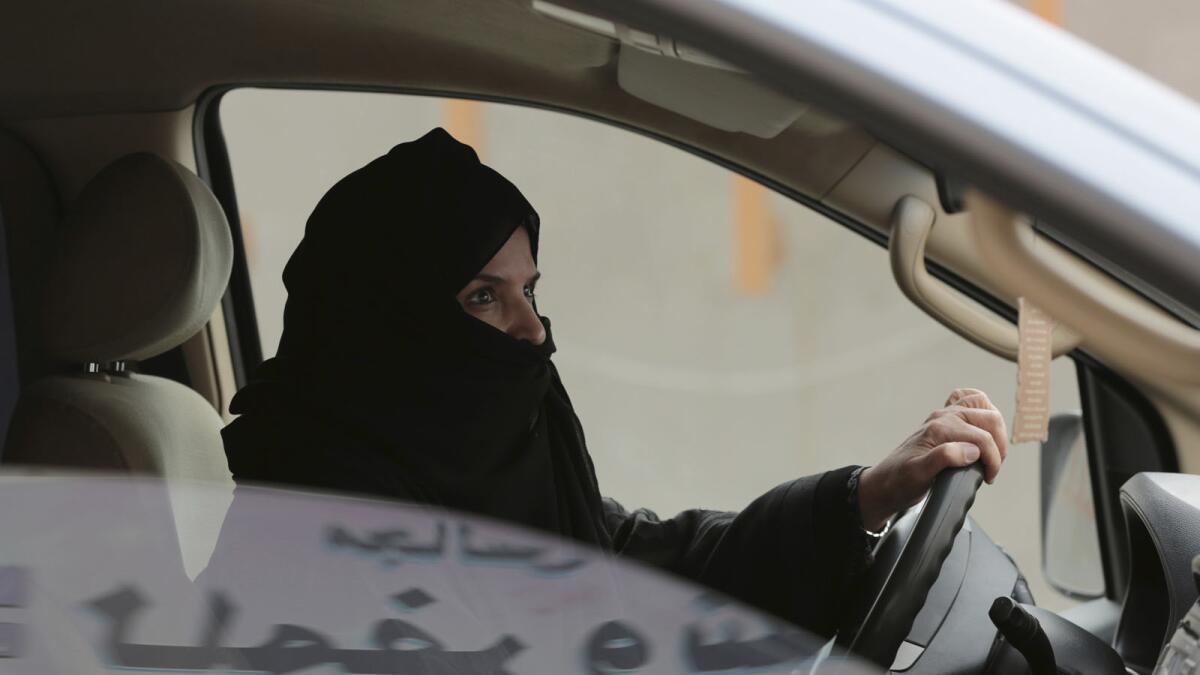 Aziza Yousef drives a car in Riyadh in March 2014 as part of a campaign to defy Saudi Arabia's ban on driving, which was lifted last year.