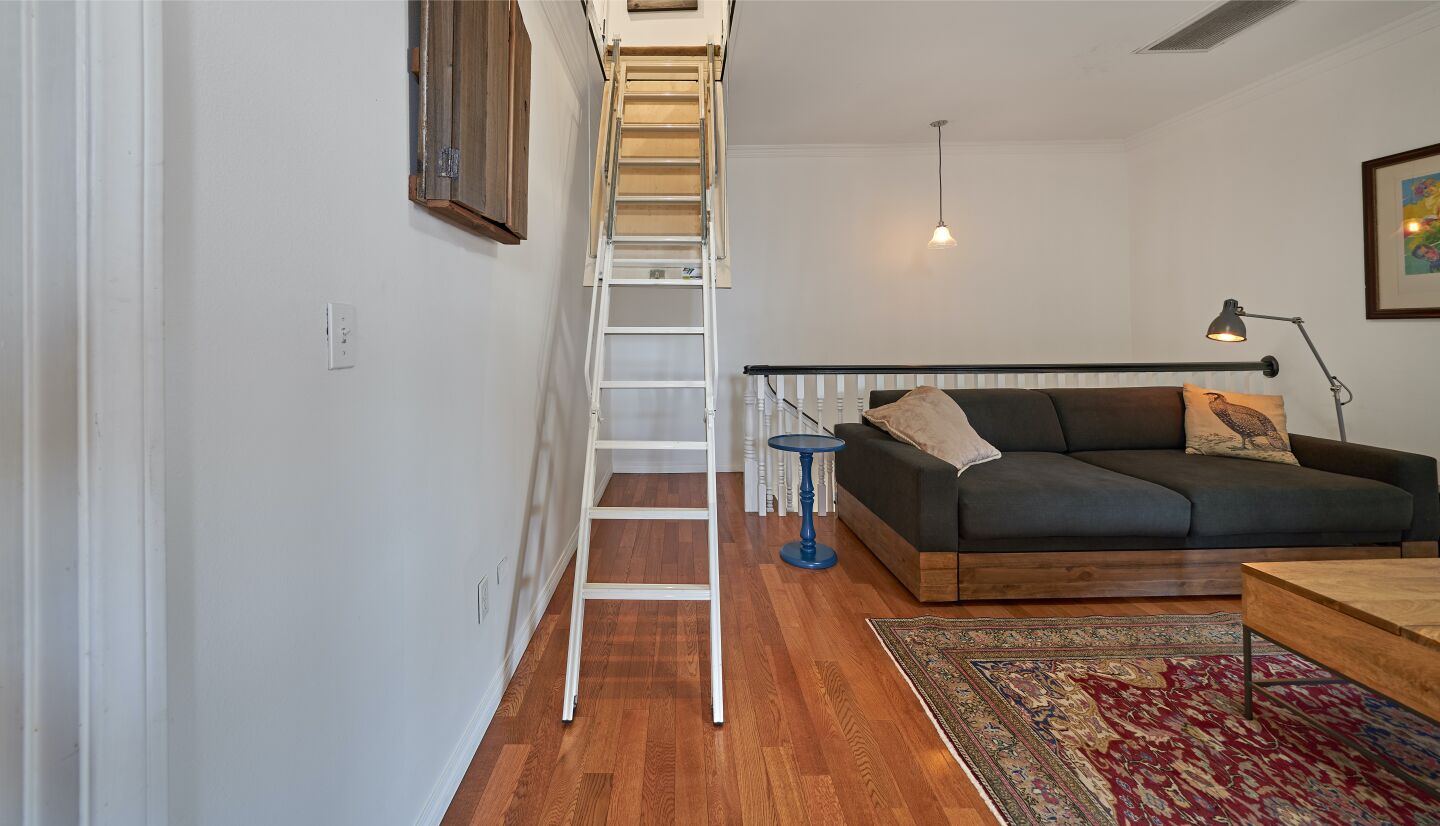 A ladder leads from the den to the attic opening.