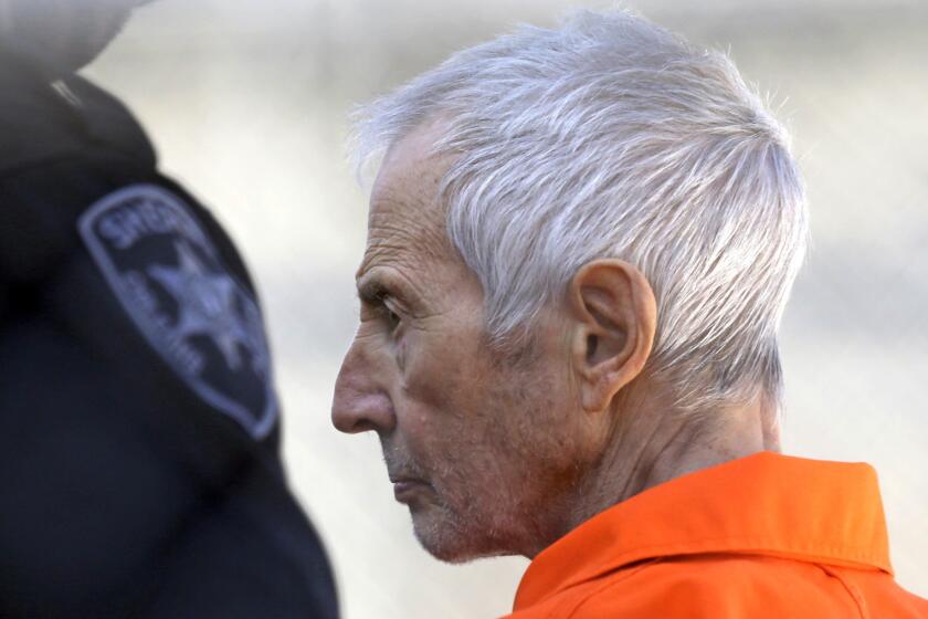 Robert Durst is escorted into prison after his arraignment in New Orleans on Tuesday.