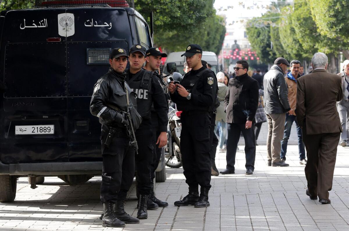 Tunisian security forces stand guard at Bourguiba Avenue, in Tunis, Tunisia, on Friday. Tunisian authorities imposed a night-time curfew across the country following violent protests against unemployment.