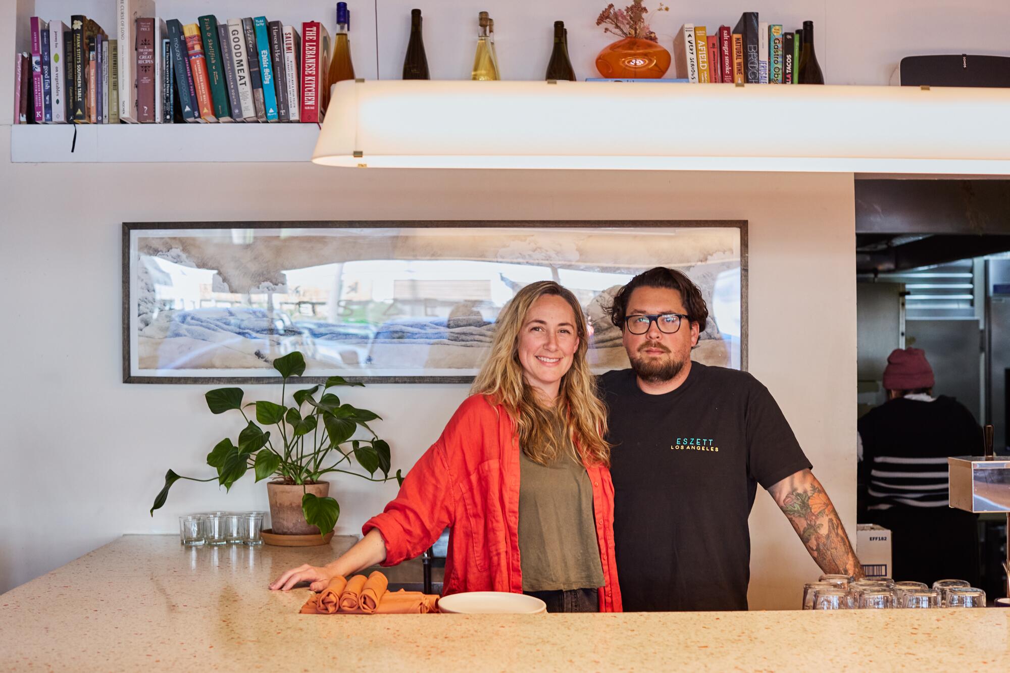 Spencer and Sabrina Bezaire stand behind a counter.