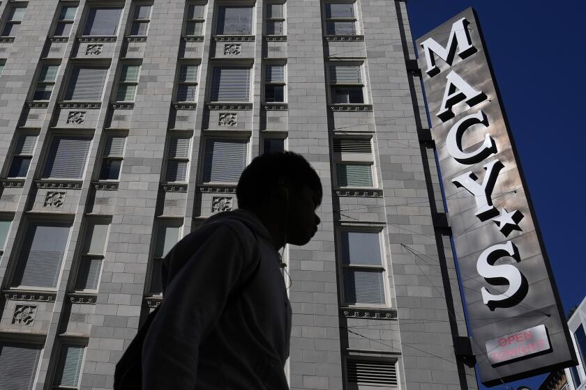 FILE - A pedestrian walks near a Macy's store in San Francisco on March 17, 2024. Macy's reports earning on Tuesday, May 21, 2024. (AP Photo/Jeff Chiu, File)