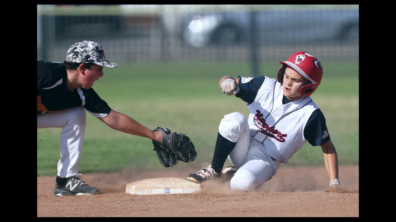 Newport Harbor player #23 Jake Shabin gets to second base safely vs. Pacific Grove in PONY League Bronco Division West Zone first round game at York Field in Whittier on Thursday, July 26, 2018.