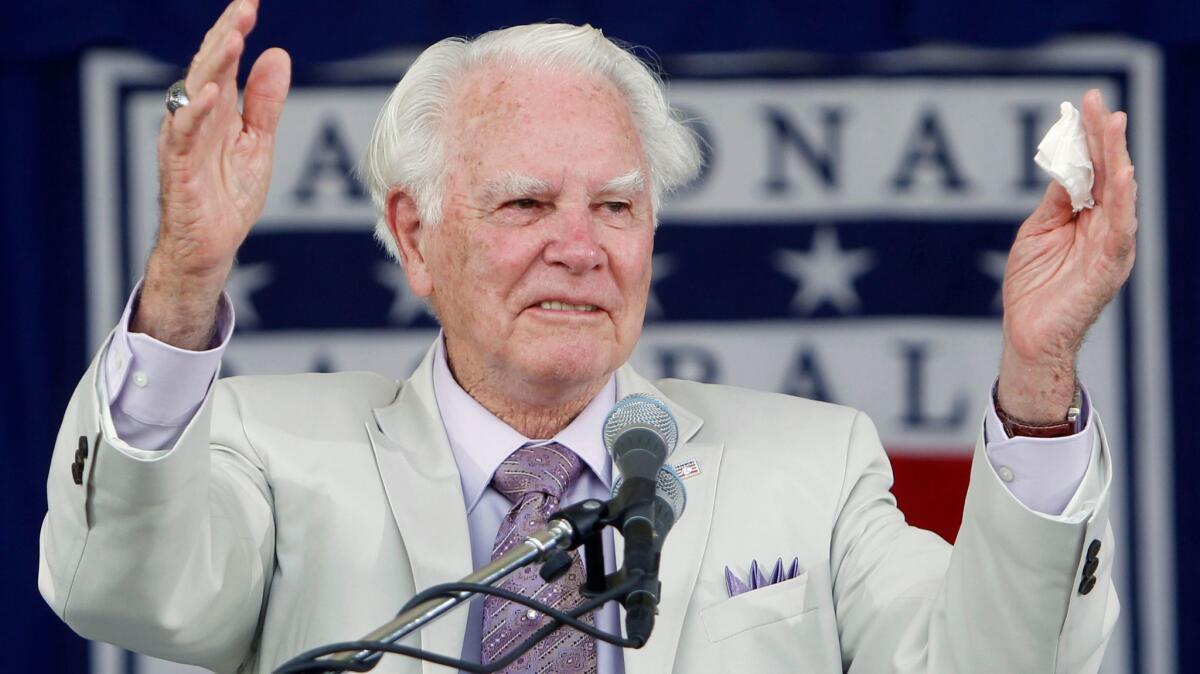 Doug Harvey acknowledges applause after his Baseball Hall of Fame induction in Cooperstown, N.Y., in 2010.