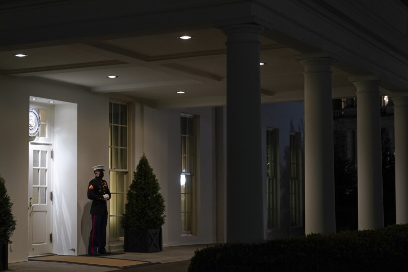 A Marine stands outside the entrance to the West Wing of the White House, signifying President Donald Trump is in the Oval Office, Thursday, Jan. 7, 2021, in Washington. (AP Photo/Patrick Semansky)