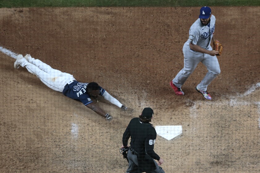 Arlington, Texas, Saturday, October 24, 2020 Tampa Bay Rays left fielder Randy Arozarena (56) scores the winning run.